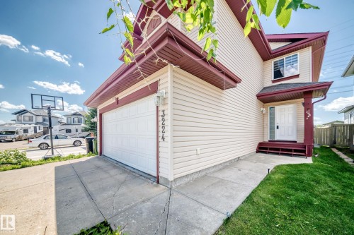 Cream-colored siding facade with contrasting burgundy trim - 3224 26 Street, Edmonton, AB 