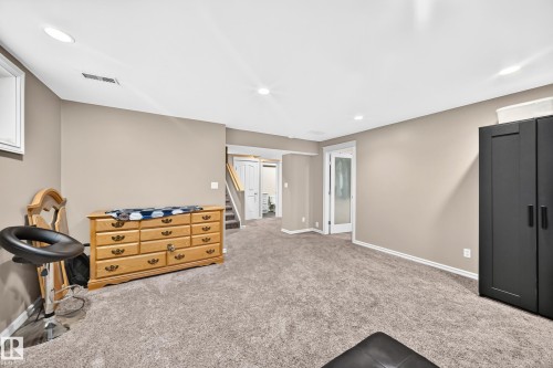 Spacious room featuring neutral wall tones and plush carpeting - 3224 26 Street, Edmonton, AB 