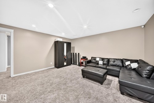 Spacious room featuring neutral-toned walls and plush gray carpeting - 3224 26 Street, Edmonton, AB 
