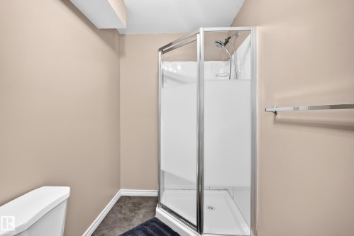 Corner shower enclosure with frosted glass panels and chrome hardware - 3224 26 Street, Edmonton, AB 