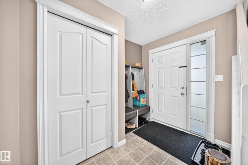 Entryway featuring a paneled door with a frosted sidelight, offering natural light - 3224 26 Street, Edmonton, AB 