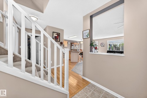 Carpeted staircase with white balusters and handrail - 3224 26 Street, Edmonton, AB 