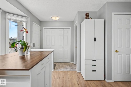 Kitchen island with wood-finish countertop and white cabinetry - 2123 36 Avenue, Edmonton, AB - Indoor Photo Showing Other Room