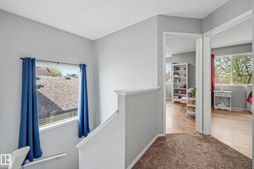 Upper-level hallway with neutral wall paint and textured carpeting - 2123 36 Avenue, Edmonton, AB - Indoor Photo Showing Other Room
