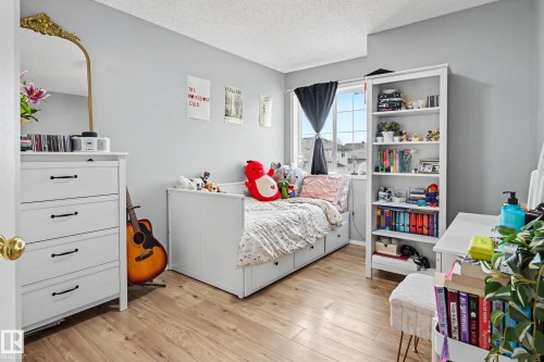 Bright interior space with wood-finish flooring and light gray walls - 2123 36 Avenue, Edmonton, AB - Indoor Photo Showing Bedroom