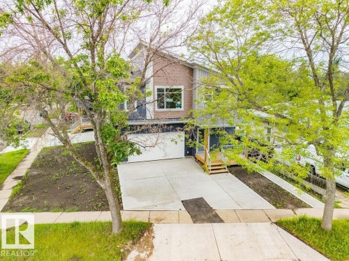 Contemporary split-level residence featuring a two-tone facade with dark siding and brick-finish accents - 15004 62 Street, Edmonton, AB 