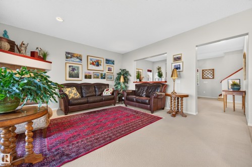 Spacious living area featuring neutral carpeting and light gray wall tones - 1310 82 Street, Edmonton, AB 