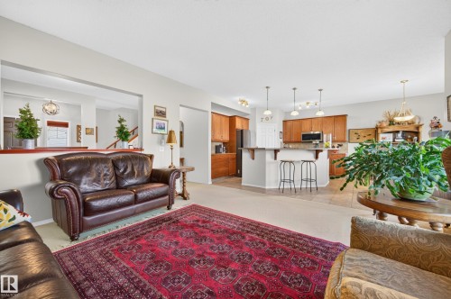 Open-concept living area with light-colored walls and carpeted flooring - 1310 82 Street, Edmonton, AB 