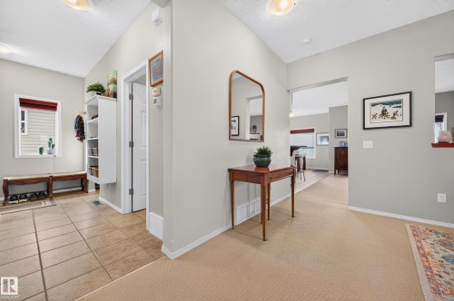 Entryway featuring tile flooring, white trim, and a built-in shelving unit - 1310 82 Street, Edmonton, AB 