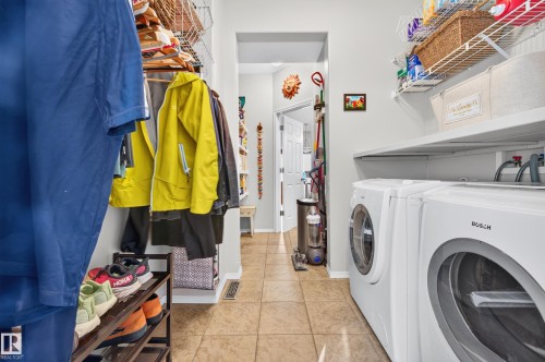 Laundry area with tile flooring and built-in shelving - 1310 82 Street, Edmonton, AB 
