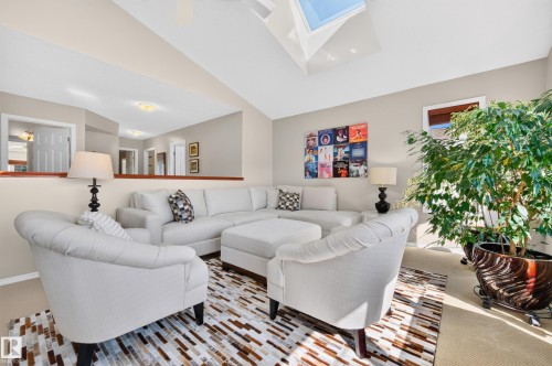 Vaulted ceiling with skylight over the neutral-toned living space - 1310 82 Street, Edmonton, AB 