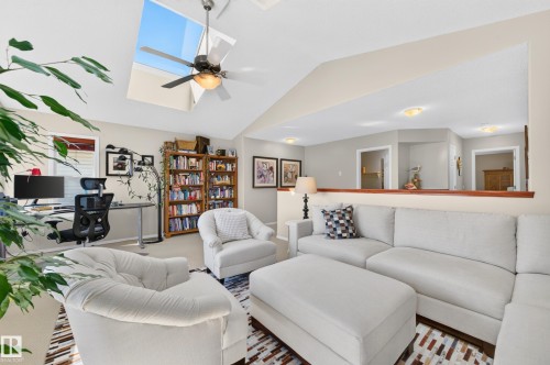 Living area featuring vaulted ceilings, skylights, and a ceiling fan - 1310 82 Street, Edmonton, AB 