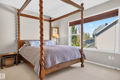 Carpeted room with neutral wall tones and a prominent window - 1310 82 Street, Edmonton, AB 