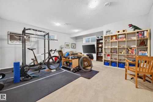 Versatile room featuring light carpeting, neutral wall colors, and recessed lighting - 1310 82 Street, Edmonton, AB 