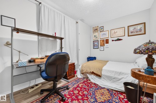 Versatile interior room featuring wood-finish flooring and ample wall space - 1310 82 Street, Edmonton, AB 