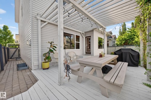 Expansive outdoor deck featuring a light-toned pergola with string lighting - 1310 82 Street, Edmonton, AB 