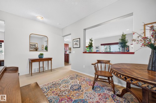 Interior entry area featuring light-toned walls, overhead lighting, and carpet flooring - 1310 82 Street, Edmonton, AB 