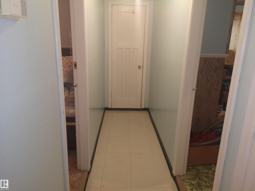 Hallway to front door. Living room on right. - 8751 76 Avenue Nw, Edmonton, AB 