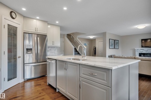 173 Reichert, Beaumont, AB - Indoor Photo Showing Kitchen With Fireplace With Stainless Steel Kitchen With Double Sink With Upgraded Kitchen