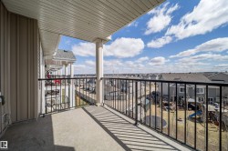 Concrete balcony with black metal railings, supported by a classic column - 