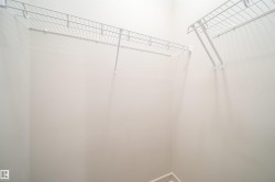 Closet storage featuring white wire shelving units and light-toned wall paint - 