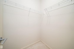 Integrated wire shelving system with light-toned walls and carpet flooring - 