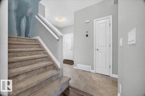 Carpeted staircase with white handrails - 17203 71 Street, Edmonton, AB 