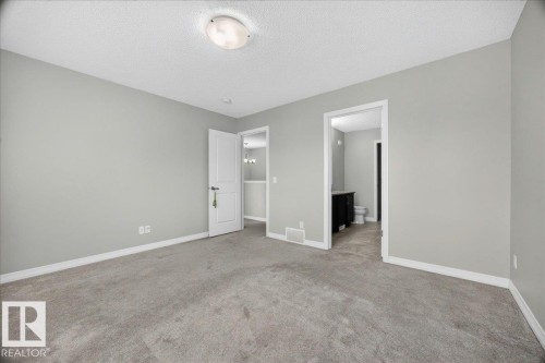 Spacious room featuring gray carpet flooring and light gray walls - 17203 71 Street, Edmonton, AB 