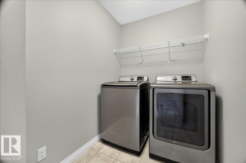Dedicated laundry area featuring a tile floor and light gray walls - 17203 71 Street, Edmonton, AB 