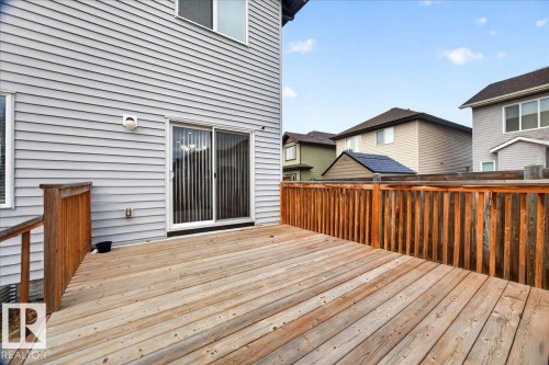 Spacious wooden deck featuring a perimeter railing and direct access via a sliding glass door - 17203 71 Street, Edmonton, AB 