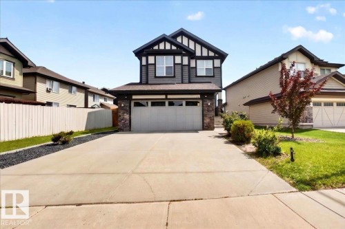 Modern two-story residence featuring dark siding with white trim accents - 17203 71 Street, Edmonton, AB 