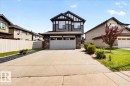 Modern two-story residence featuring dark siding with white trim accents - 17203 71 Street, Edmonton, AB 