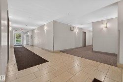 Common area featuring neutral toned wall paint, light-colored tile flooring, wall sconces, and recessed lighting - 