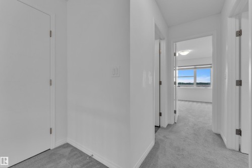 Hallway with light gray carpeting and white trim - 144 Sunwapta Way, Edmonton, AB 