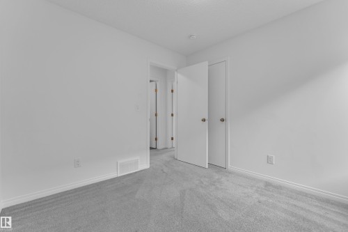 Light gray carpeting, white walls, and white trim - 144 Sunwapta Way, Edmonton, AB 