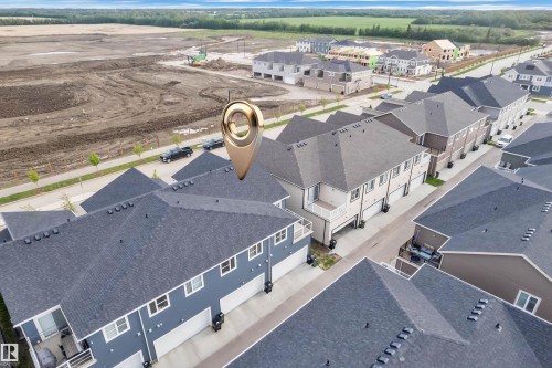 Aerial view of multiple residential properties featuring dark gray shingle roofing - 144 Sunwapta Way, Edmonton, AB 