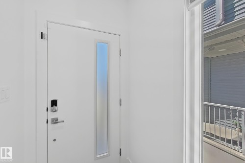 Entry door with frosted vertical lite, smart lock system, and brushed nickel hardware - 415 42 Street, Edmonton, AB 