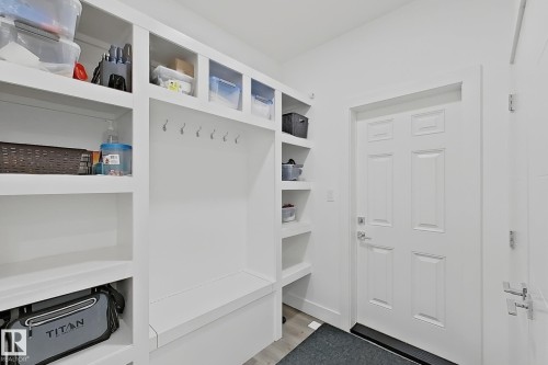 Built-in white storage unit featuring open shelving, integrated bench seating, and coat hooks - 415 42 Street, Edmonton, AB 