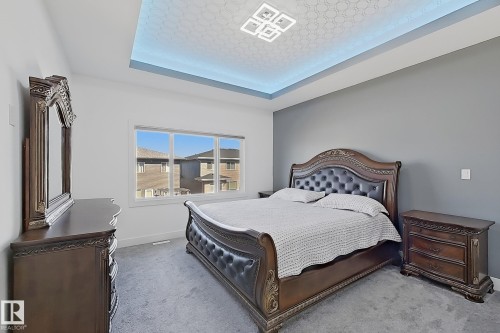 Tray ceiling featuring recessed lighting and a central flush-mount fixture - 415 42 Street, Edmonton, AB 
