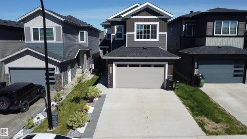 Contemporary two-story residence featuring a dark gray shingle roof and a two-car attached garage - 415 42 Street, Edmonton, AB 