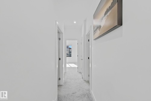 Bright hallway with recessed lighting and light-colored carpeting - 415 42 Street, Edmonton, AB 