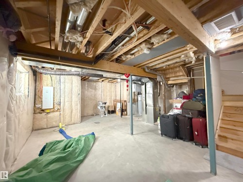 Unfinished basement with concrete flooring and exposed wooden joists - 415 42 Street, Edmonton, AB 