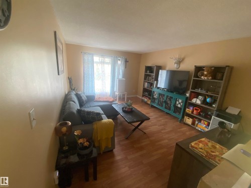 Open-concept living area featuring wood-finish flooring - 5713 44A Street, Vegreville, AB 