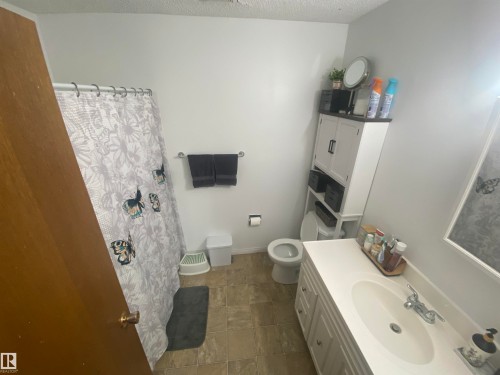 Bathroom with a single vanity, white countertop, and integrated sink - 5713 44A Street, Vegreville, AB 