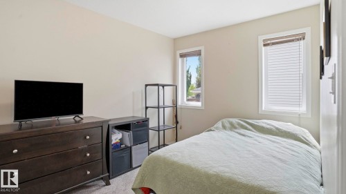 Neutral-toned walls complement the light grey carpeted flooring - 6105 52 Avenue, Beaumont, AB 