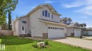 Two-story residence featuring light gray siding and stone veneer accents - 6105 52 Avenue, Beaumont, AB 