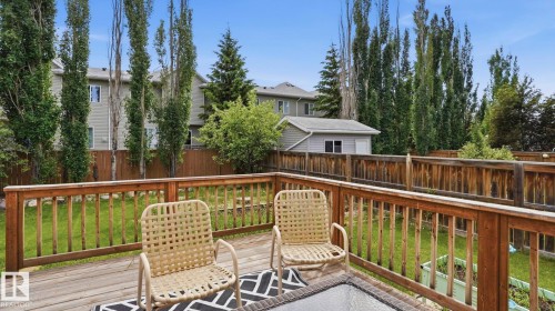 Wood-finish deck with a natural wood railing - 6105 52 Avenue, Beaumont, AB 