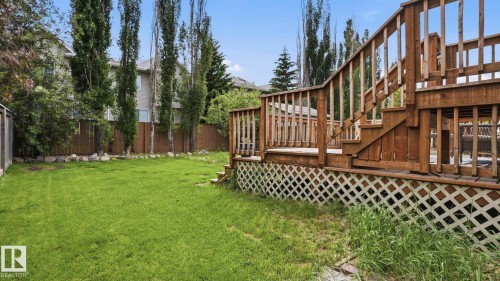 Multi-level wood deck featuring lattice skirting, railings, and stairs - 6105 52 Avenue, Beaumont, AB 