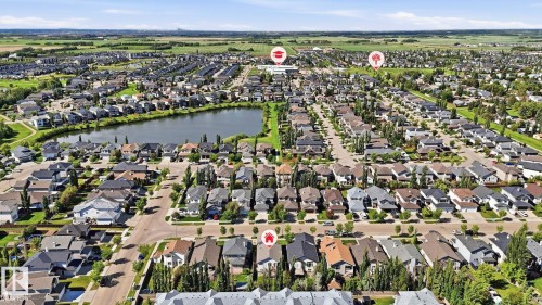Aerial perspective of a residential community featuring a central lake - 6105 52 Avenue, Beaumont, AB 