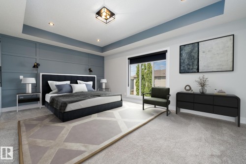 Spacious bedroom featuring light grey carpeting, recessed ceiling lighting, a tray ceiling with a blue accent, and a large window with a black roller blind - 17320 9 Avenue, Edmonton, AB 